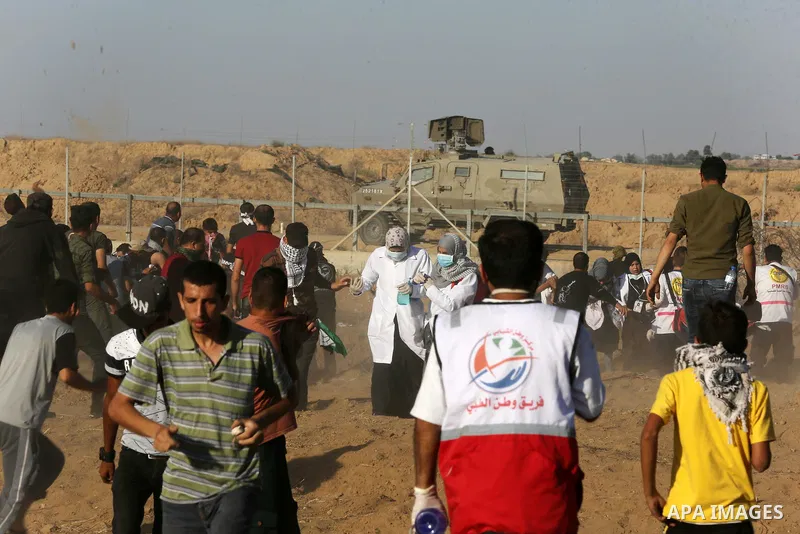 A wounded Palestinian protester is evacuated during clashes with Israeli troops following the tents protest where Palestinians demand the right to return to their homeland at the Israel-Gaza border, in Khan Younis in the...