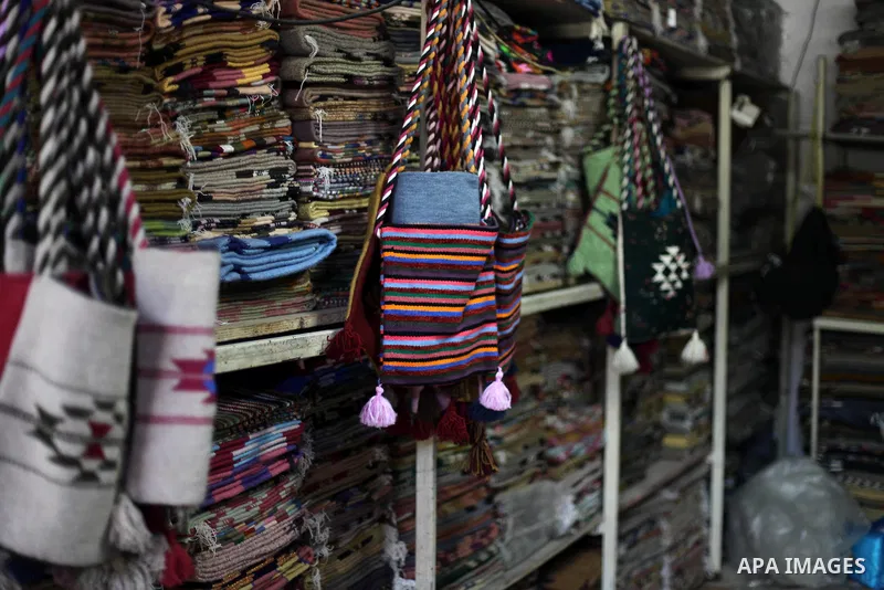 Palestinian workers weave carpets in a workshop in Gaza city on July 06, 2019. Weaving sheep's wool into traditional carpets is one oldest professions, it takes skill, patience and steady hand. Photo by Mahmoud Ajjour