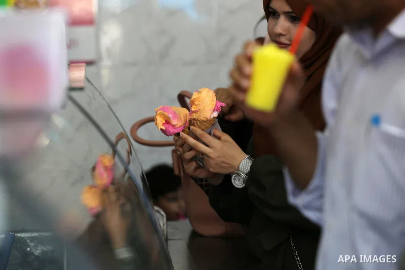 Palestinians buy ice cream during a hot summer day, in Gaza city on July 10, 2019. Wednesday’s temperature is set to rise and approach 4°C above the seasonal average with warm to very warm conditions. Photo by Ashraf Amr...