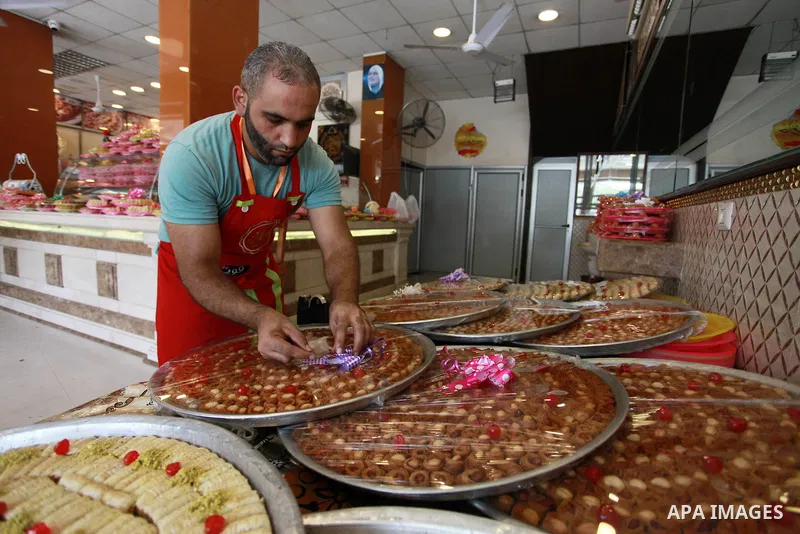 A Palestinian worker prepares sweets ahead of the results of high school exams, known as ''Tawjihi'', at a workshop in Gaza city, July 17, 2019. Photo by Mahmoud Ajjour