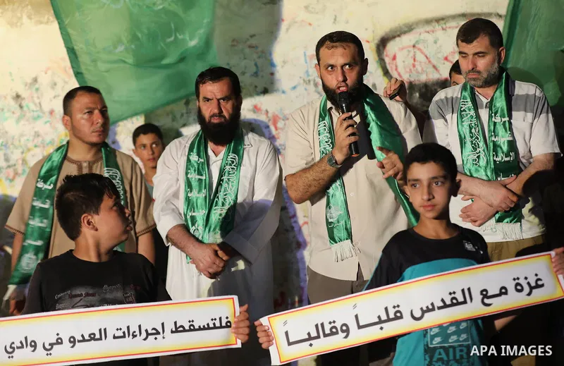 Palestinian Hamas supporters take part in a protest against the demolition of Palestinian buildings in the the Palestinian village of Sur Baher, in Gaza city July 22, 2019. Israel demolished a number of Palestinian homes...