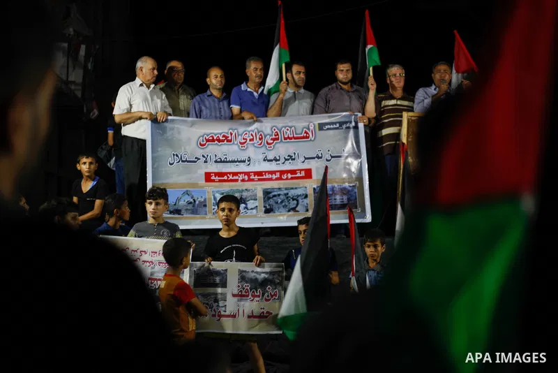 Palestinian protesters take part in a demonstration agianst the demolition of Palestinian buildings by Israeli security forces in the Palestinian village of Sur Baher in East Jerusalem, in Jabalia in the northen Gaza Str...