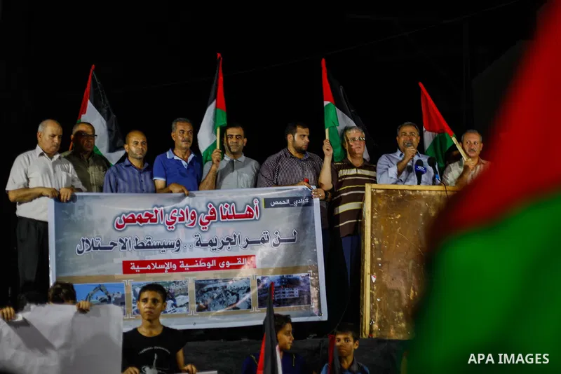 Palestinian protesters take part in a demonstration agianst the demolition of Palestinian buildings by Israeli security forces in the Palestinian village of Sur Baher in East Jerusalem, in Jabalia in the northen Gaza Str...