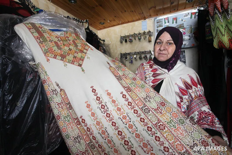Palestinian women sew traditional heritage embroidery at a workshop in Gaza city, ahead of traditional Palestinian Costume Day, on July 25, 2019. Palestinian National Costume Day is an event organized by a group of youth...