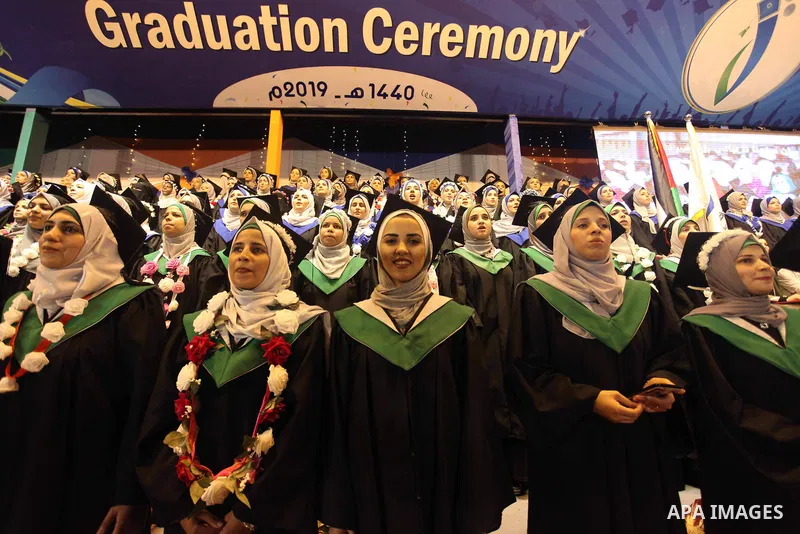 Palestinian students attend their graduation ceremony at University college of applied sciences, in Gaza city on July 29, 2019. Photo by Mahmoud Ajjour