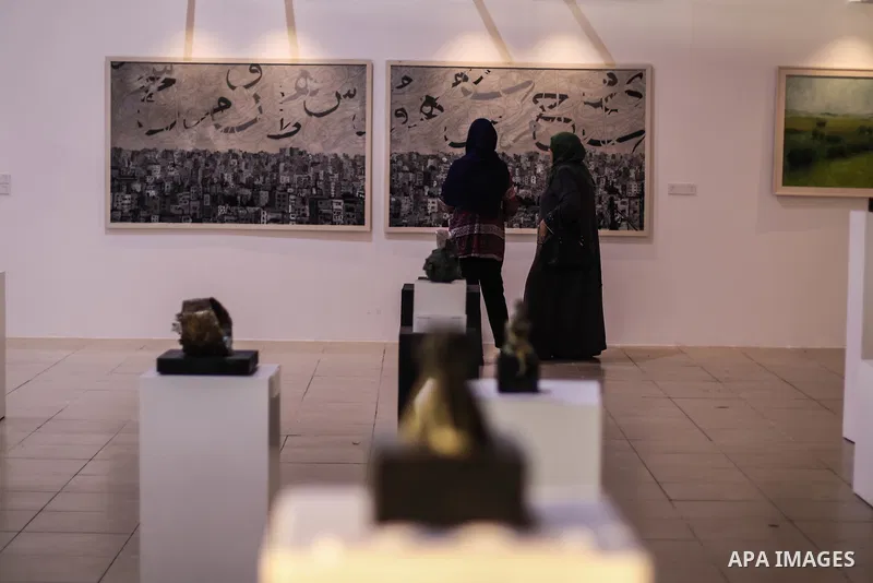 Palestinians attend the art show of Contemplative Contrasts, organised by General Union of Cultural centers, in Gaza city on July 30, 2019. Photo by Mahmoud Al-Hindi