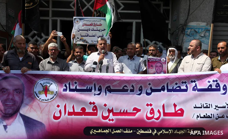 Palestinian supporters of the Islamic Jihad movement take part during a protest to show solidarity with Palestinian Prisoner Tareq Qa'adan on hunger strike at Israeli jails, in Gaza City on August 4, 2019. Photo by Mahmo...