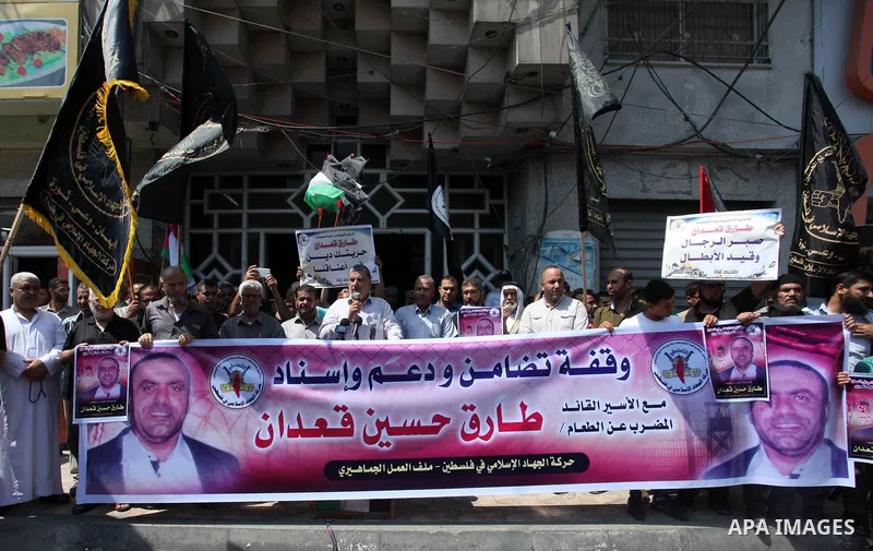 Palestinian supporters of the Islamic Jihad movement take part during a protest to show solidarity with Palestinian Prisoner Tareq Qa'adan on hunger strike at Israeli jails, in Gaza City on August 4, 2019. Photo by Mahmo...