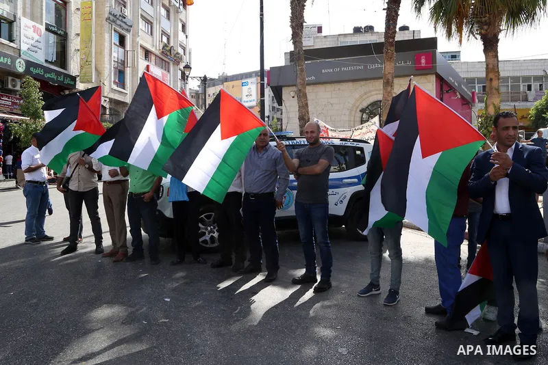 Palestinians take part in a protest in solidarity with prisoners in Israeli jails, in the West Bank city of Ramallah, on August 05, 2019. 40 Palestinian prisoners in Israeli jails are to begin a hunger strike today in su...