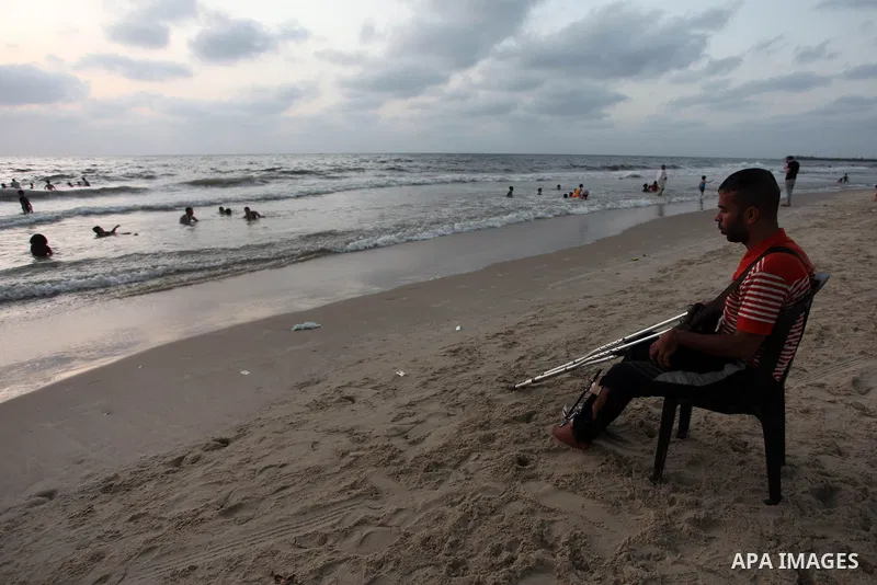 Palestinians with disabilities enjoy the beach at a cafe on the shores of the Mediterranean sea in Gaza city, on August 05, 2019. Gaza Municipality opened the first accessible beach for disabled individuals, old people a...