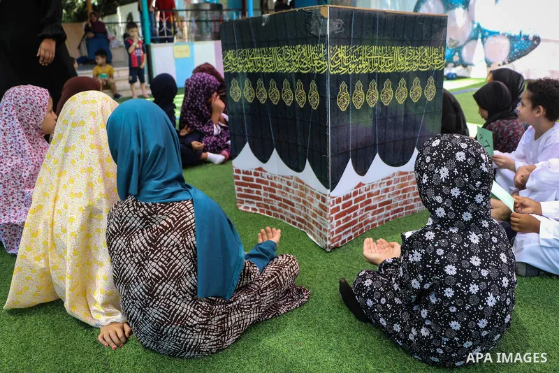 Palestinian children gather around a makeshift cube representing the holy Kaaba, as part of training children how to perform Hajj pilgrimage, in Gaza city on August 06, 2019. Muslims from around the world flood Saudi cit...