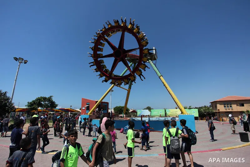 Palestinian children play at Sharm Park in Gaza city on August 06, 2019. Photo by Mahmoud Ajjour