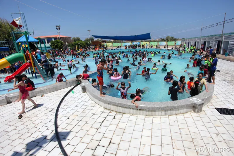 Palestinian children enjoy swimming in a pool at Sharm Park in Gaza city on August 06, 2019. Photo by Mahmoud Ajjour