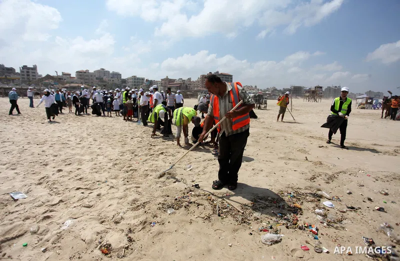 Palestinian youths take part in the cleaning of the beach along the shore of the Mediterranean Sea under the title "Our beach is clean with our behavior" organaized by JICA Alumni Association in Palestine, in Gaza city o...