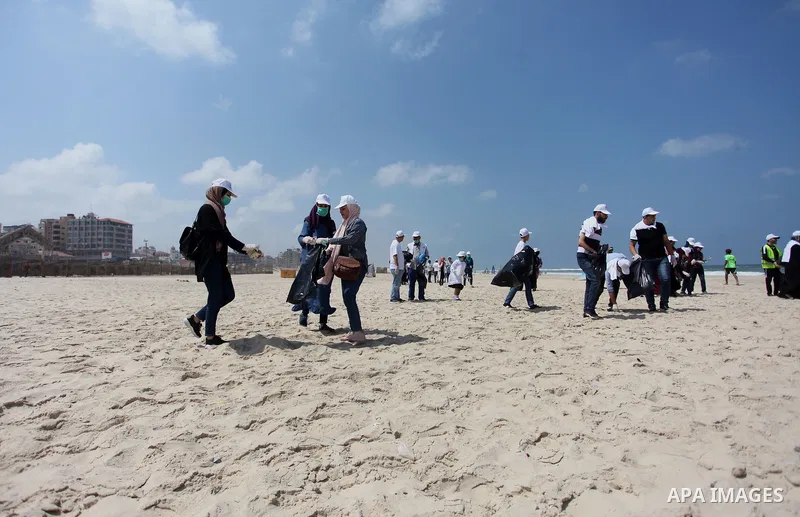Palestinian youths take part in the cleaning of the beach along the shore of the Mediterranean Sea under the title "Our beach is clean with our behavior" organaized by JICA Alumni Association in Palestine, in Gaza city o...