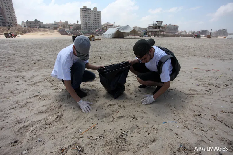 Palestinian youths take part in the cleaning of the beach along the shore of the Mediterranean Sea under the title "Our beach is clean with our behavior" organaized by JICA Alumni Association in Palestine, in Gaza city o...