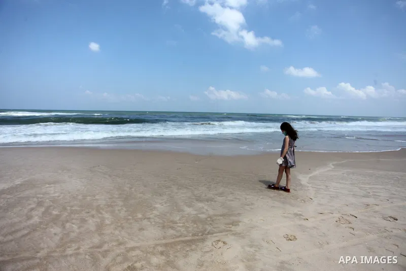 Palestinian youths take part in the cleaning of the beach along the shore of the Mediterranean Sea under the title "Our beach is clean with our behavior" organaized by JICA Alumni Association in Palestine, in Gaza city o...