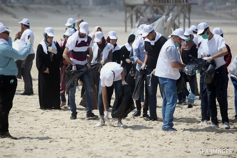 Palestinian youths take part in the cleaning of the beach along the shore of the Mediterranean Sea under the title "Our beach is clean with our behavior" organaized by JICA Alumni Association in Palestine, in Gaza city o...
