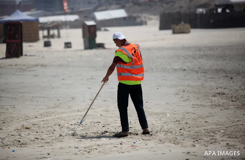 Palestinian youths take part in the cleaning of the beach along the shore of the Mediterranean Sea under the title "Our beach is clean with our behavior" organaized by JICA Alumni Association in Palestine, in Gaza city o...