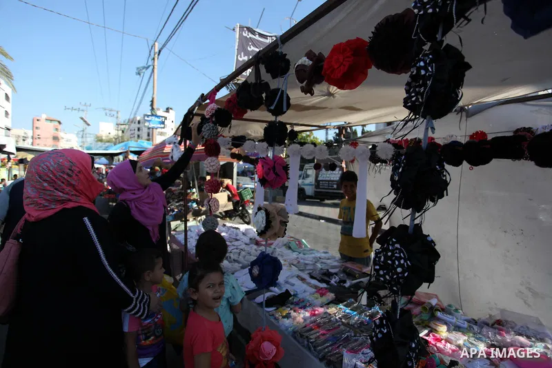 Palestinian shop at a market ahead of Eid al-Adha festival Gaza city on August 10, 2019. Muslims across the world are preparing for the Eid al-Adha holiday when custom requires the faithful to make a sacrifice. Photo by...