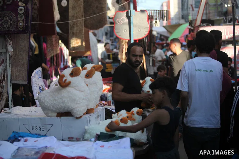 Palestinian shop at a market ahead of Eid al-Adha festival Gaza city on August 10, 2019. Muslims across the world are preparing for the Eid al-Adha holiday when custom requires the faithful to make a sacrifice. Photo by...