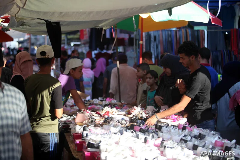 Palestinian shop at a market ahead of Eid al-Adha festival Gaza city on August 10, 2019. Muslims across the world are preparing for the Eid al-Adha holiday when custom requires the faithful to make a sacrifice. Photo by...