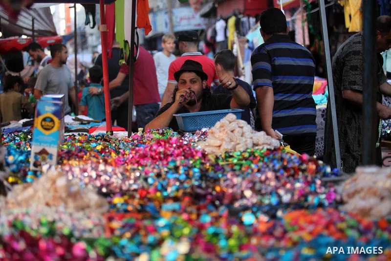 Palestinian shop at a market ahead of Eid al-Adha festival Gaza city on August 10, 2019. Muslims across the world are preparing for the Eid al-Adha holiday when custom requires the faithful to make a sacrifice. Photo by...