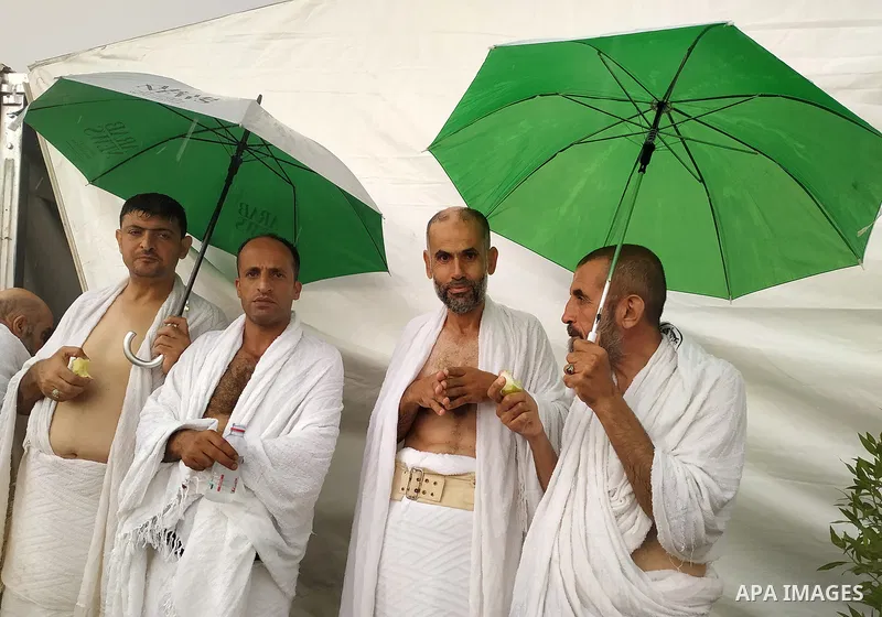 Palestinian piligrims gather near their tents during a rainy and windy weather weather, as they take part in one of the Hajj rituals southeast of the Saudi holy city of Mecca on August 10, 2019. More than 2 million pilgr...