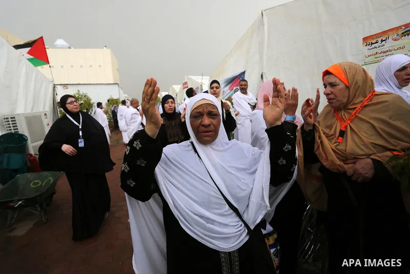 Palestinian piligrims gather near their tents during a rainy and windy weather weather, as they take part in one of the Hajj rituals southeast of the Saudi holy city of Mecca on August 10, 2019. More than 2 million pilgr...