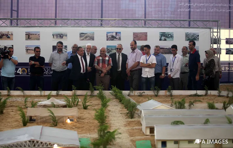 Palestinians attend an exhibition marking the 40th anniversary of the founding of the Islamic University, in Gaza city on August 19, 2019. Photo by Mahmoud Ajjour