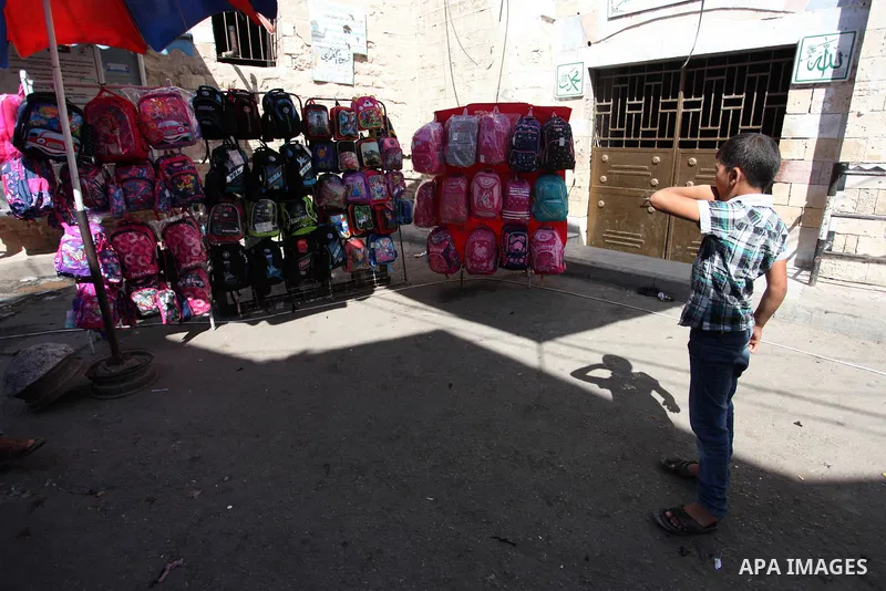 Palestinians shop at a market during preparation for the new school year in Gaza city, on August 22, 2019. Photo by Mahmoud Ajjour