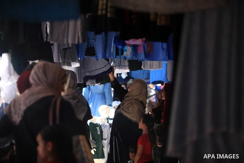 Palestinians shop at a market during preparation for the new school year in Gaza city, on August 22, 2019. Photo by Mahmoud Ajjour