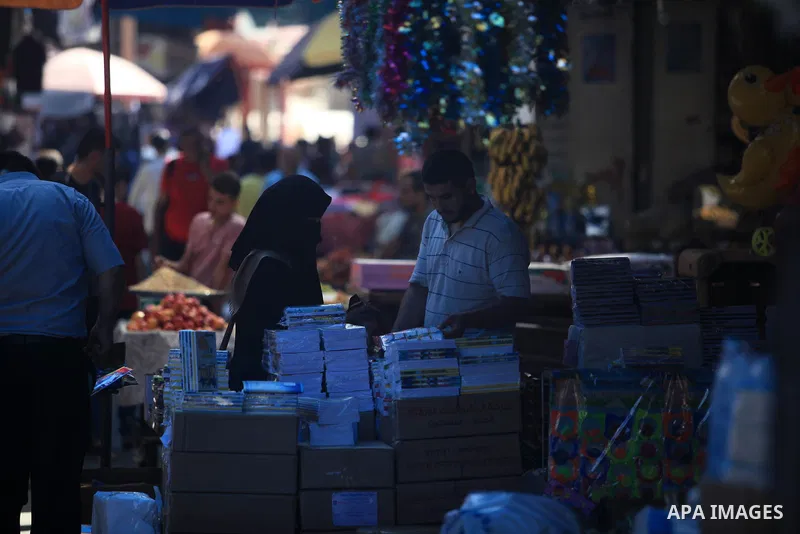 Palestinians shop at a market during preparation for the new school year in Gaza city, on August 22, 2019. Photo by Mahmoud Ajjour