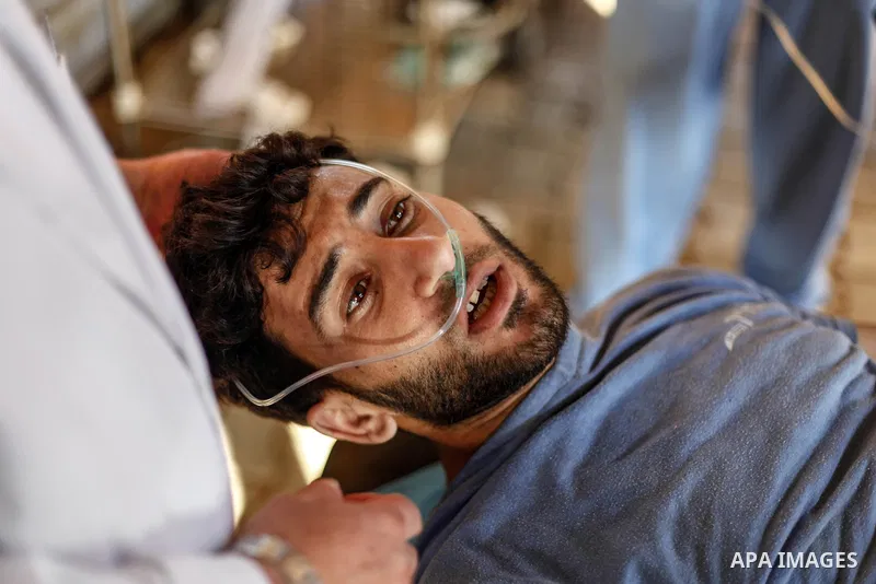 A wounded Palestinian protester is evacuated during clashes with Israeli troops following the tents protest where Palestinians demand the right to return to their homeland at the Israel-Gaza border, in Jabalia in the nor...