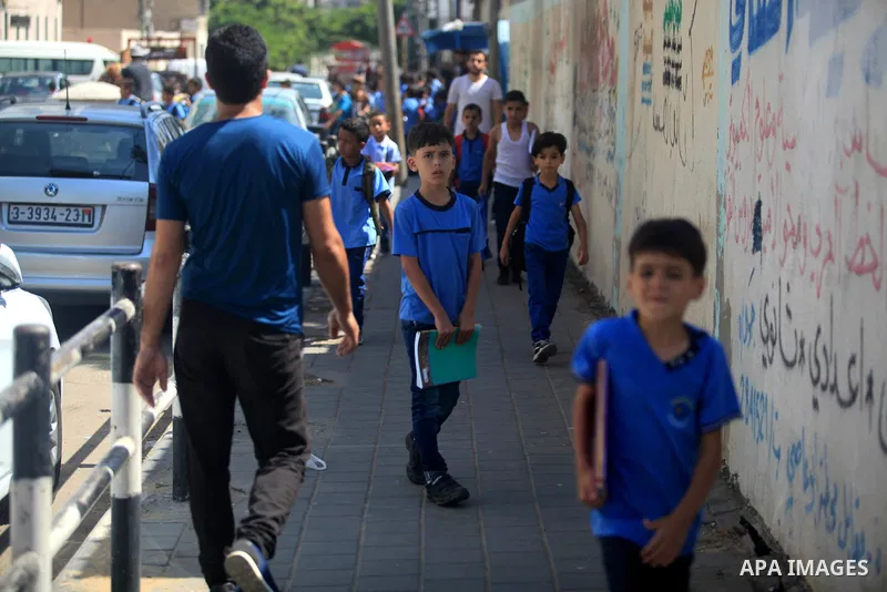 Palestinian students return back to their school in the morning of the first day of the new year study in Gaza City, on August 25, 2019. Photo by Mahmoud Ajjour
