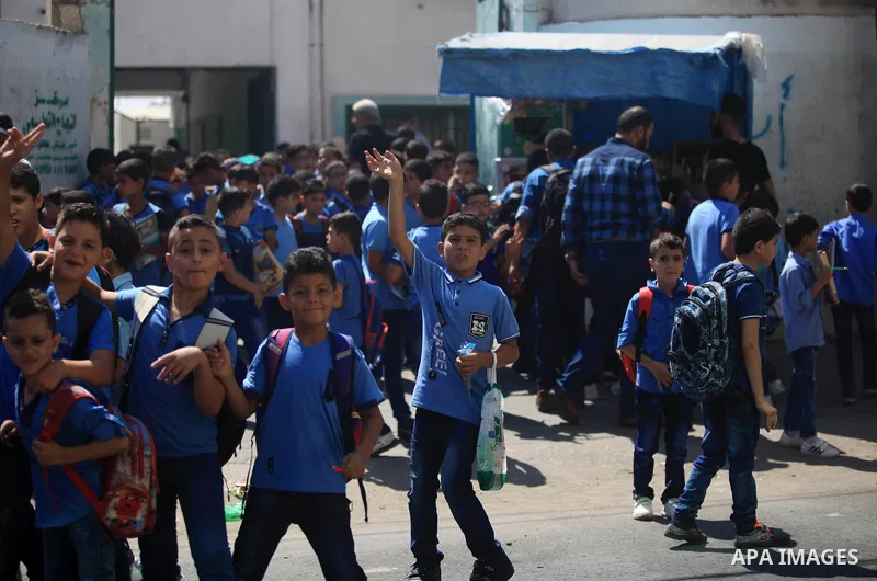 Palestinian students return back to their school in the morning of the first day of the new year study in Gaza City, on August 25, 2019. Photo by Mahmoud Ajjour