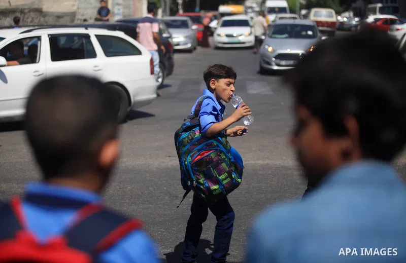 Palestinian students return back to their school in the morning of the first day of the new year study in Gaza City, on August 25, 2019. Photo by Mahmoud Ajjour
