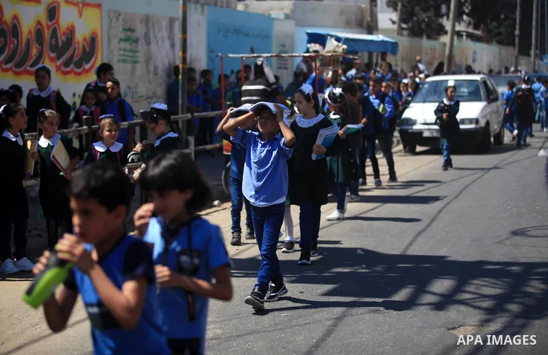 Palestinian students return back to their school in the morning of the first day of the new year study in Gaza City, on August 25, 2019. Photo by Mahmoud Ajjour