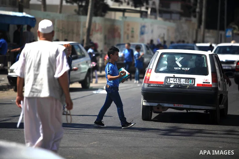 Palestinian students return back to their school in the morning of the first day of the new year study in Gaza City, on August 25, 2019. Photo by Mahmoud Ajjour