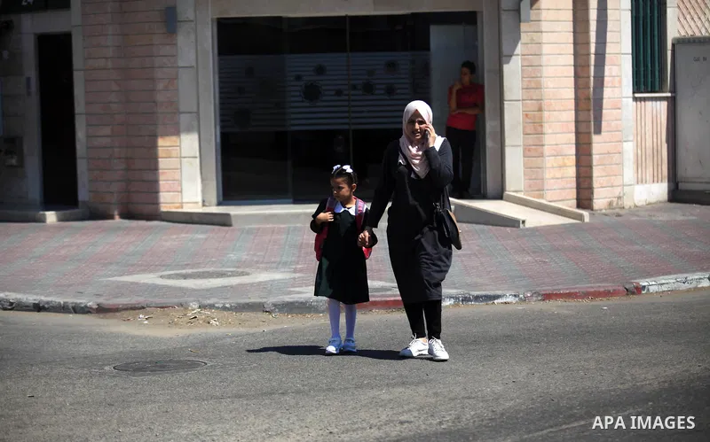 Palestinian students return back to their school in the morning of the first day of the new year study in Gaza City, on August 25, 2019. Photo by Mahmoud Ajjour