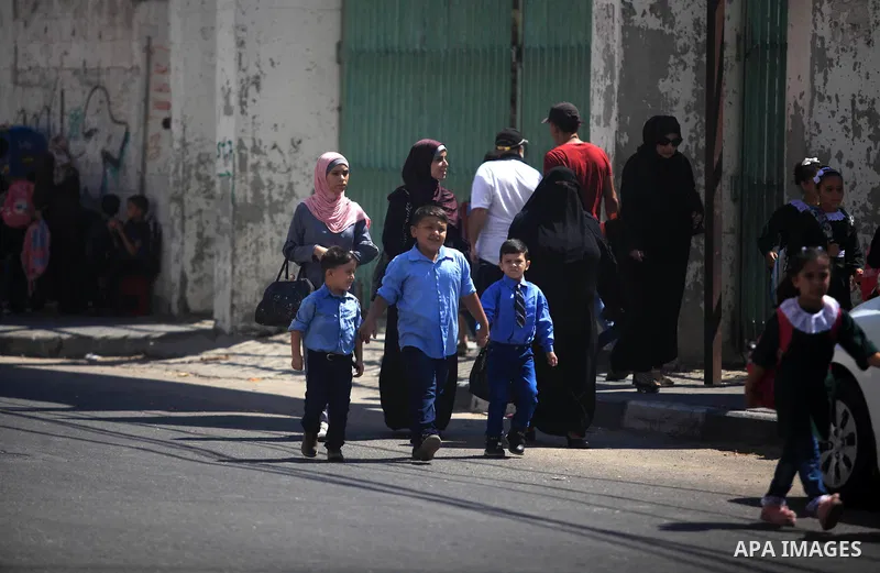 Palestinian students return back to their school in the morning of the first day of the new year study in Gaza City, on August 25, 2019. Photo by Mahmoud Ajjour
