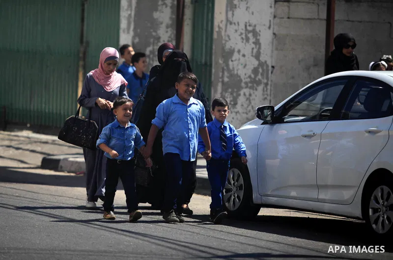 Palestinian students return back to their school in the morning of the first day of the new year study in Gaza City, on August 25, 2019. Photo by Mahmoud Ajjour