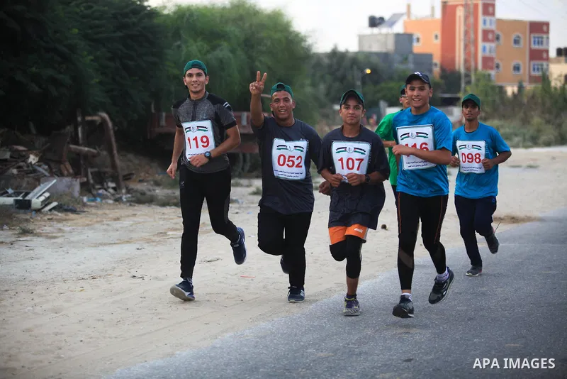 Palestinians take part in "Athletes Against Siege" marathon, organised by the National Authority of Great March of Return and Breaking the Siege, in protest against the Israeli blockade on Gaza Strip, in Gaza city on Aug...
