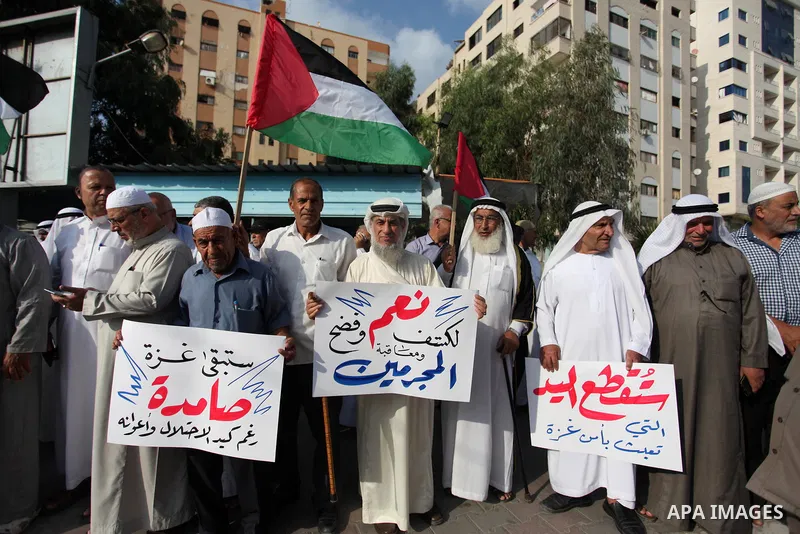 Palestinian notables and figures take part in a protest in support of Palestinian policemen at the site of attacks the killed three policemen and the main policemen station, in Gaza city, August 29, 2019. Three officers...