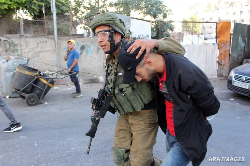 Israeli security forces detain a Palestinian proster prior to the arrival of the Israeli prime minister to attend a state memorial ceremony at the Ibrahimi mosque, in the West Bank city of Hebron on September 04, 2019. N...