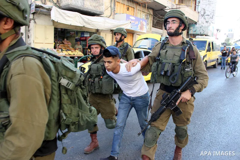 Israeli security forces detain a Palestinian proster prior to the arrival of the Israeli prime minister to attend a state memorial ceremony at the Ibrahimi mosque, in the West Bank city of Hebron on September 04, 2019. N...