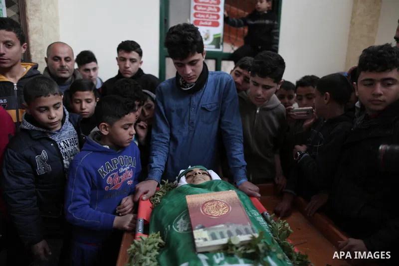 A file photo taken on January 14, 2019, shows Ali al-Ashqar, 17, (C) who was killed by Israeli troops on September 06, 2019, mourns over the body of his friend Abdul Raouf Salha, who was died of his wounds which he susta...