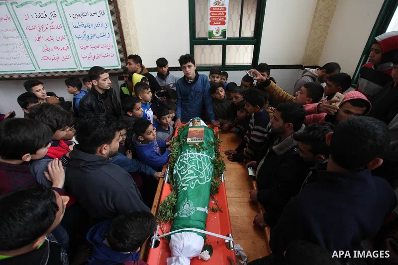 A file photo taken on January 14, 2019, shows Ali al-Ashqar, 17, (C) who was killed by Israeli troops on September 06, 2019, mourns over the body of his friend Abdul Raouf Salha, who was died of his wounds which he susta...