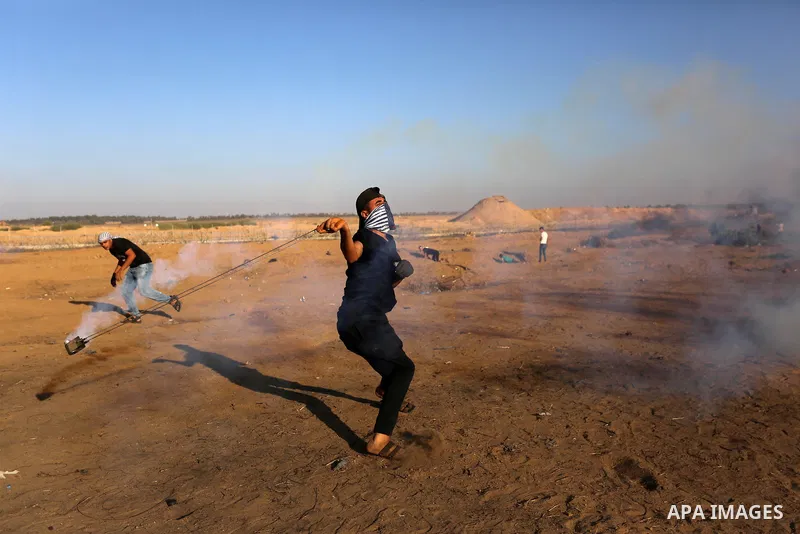 Palestinian protesters clash with Israeli troops following the tents protest where Palestinians demand the right to return to their homeland at the Israel-Gaza border, in Khan Younis in the southern Gaza Strip, September...