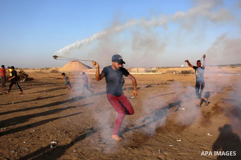 Palestinian protesters clash with Israeli troops following the tents protest where Palestinians demand the right to return to their homeland at the Israel-Gaza border, in Khan Younis in the southern Gaza Strip, September...